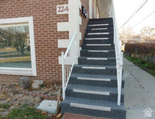 Details with stairway, brick siding, and entry steps