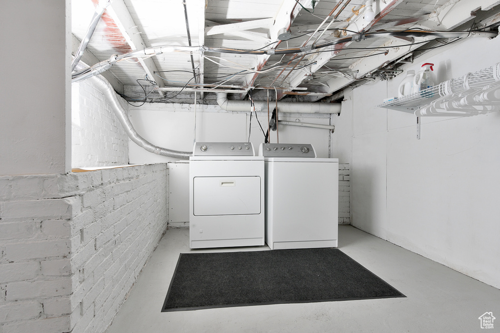 Washroom featuring laundry area and washer and clothes dryer