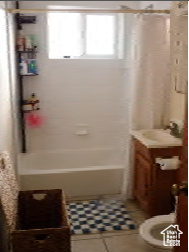 Bathroom with tile patterned flooring, toilet, and shower / washtub combination