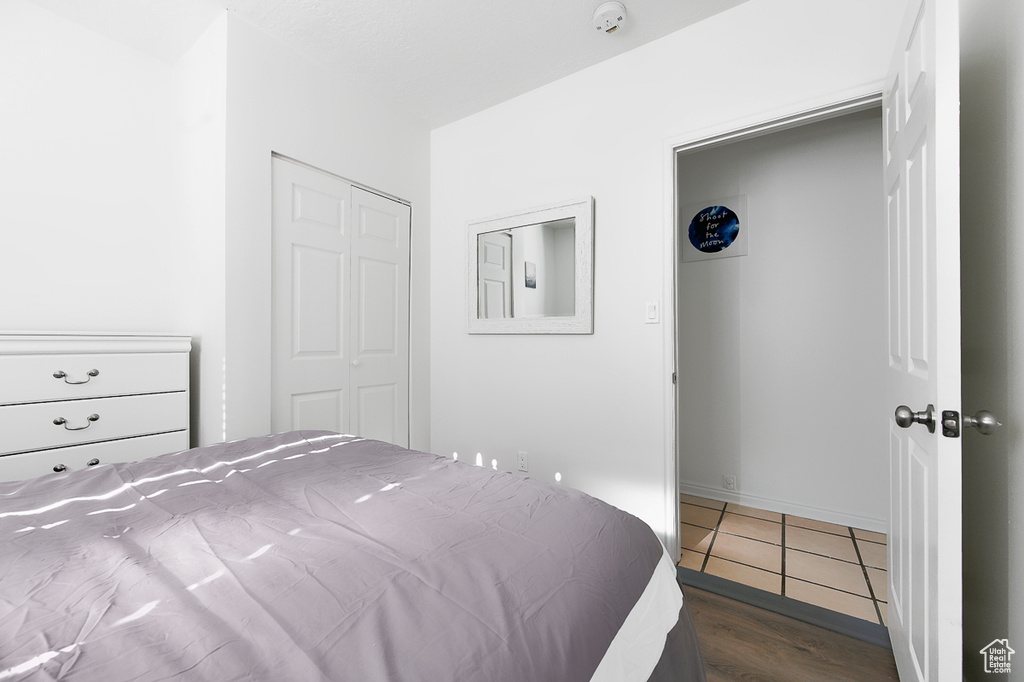 Bedroom featuring wood finished floors and a closet