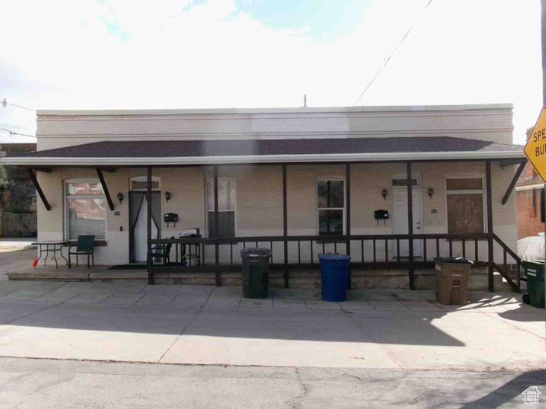 Back of house featuring covered porch
