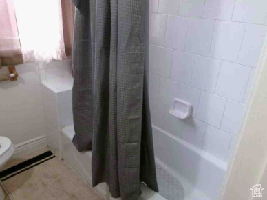 Full bathroom with toilet and shower / tub combo
