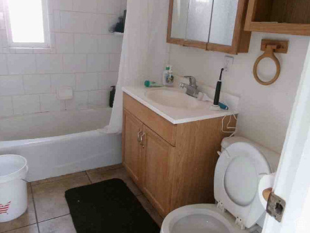 Full bath with vanity, tile patterned flooring, toilet, and shower / washtub combination