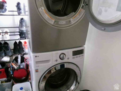 Laundry area featuring laundry area and stacked washer and clothes dryer