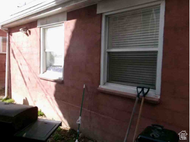 View of side of home featuring stucco siding