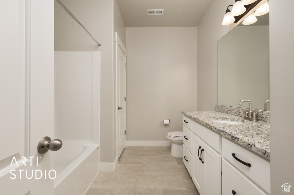 Bathroom featuring toilet, visible vents, baseboards, and vanity