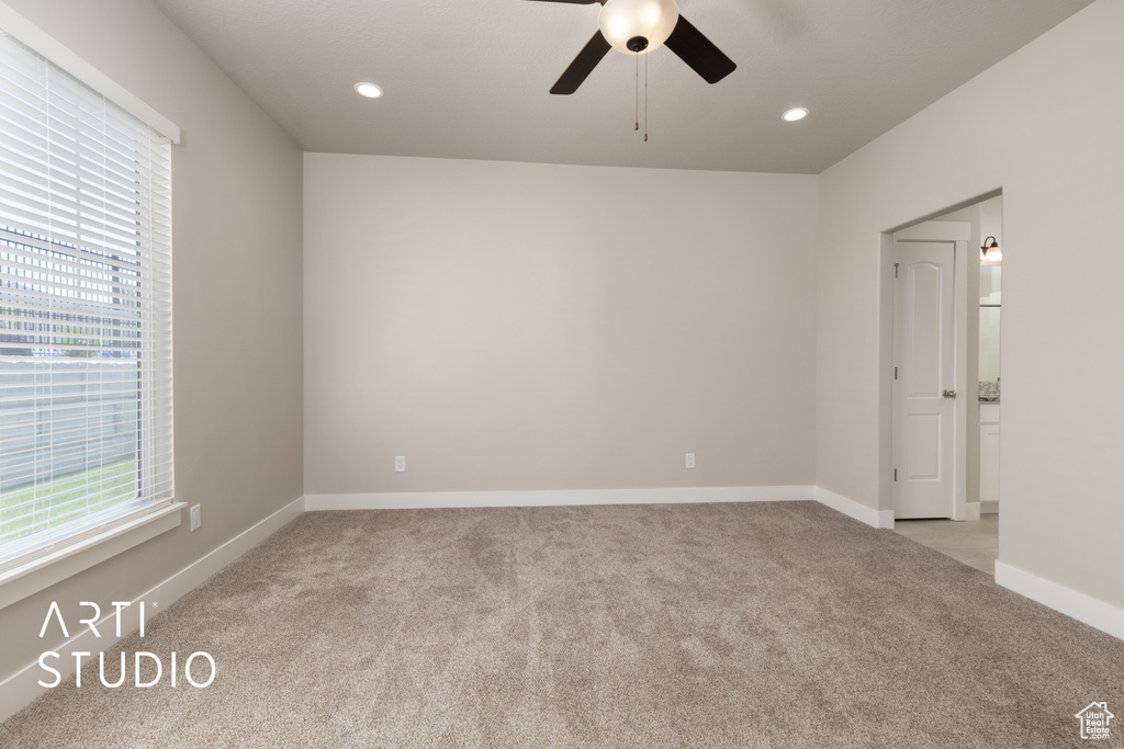 Spare room with light colored carpet, baseboards, ceiling fan, and recessed lighting