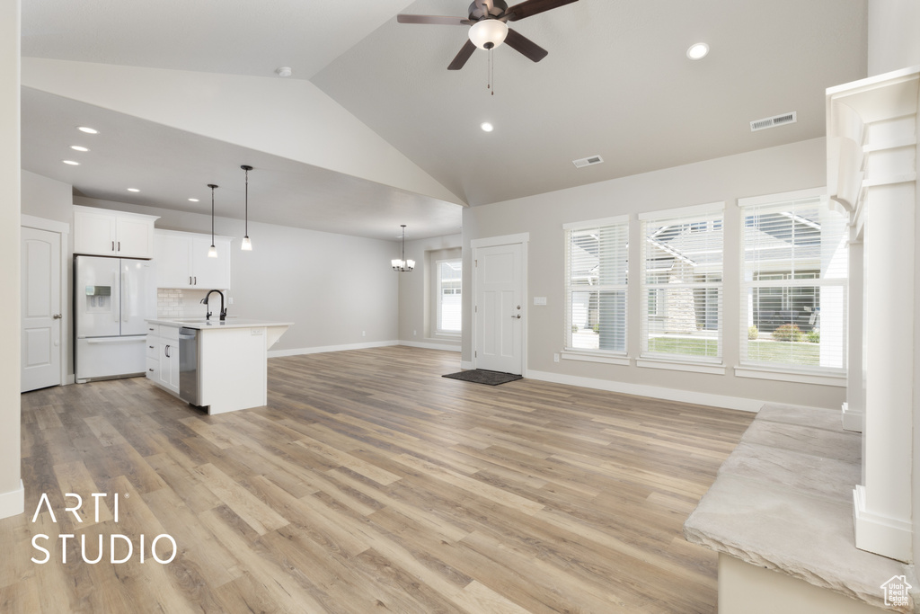 Unfurnished living room with a ceiling fan, recessed lighting, visible vents, and a sink