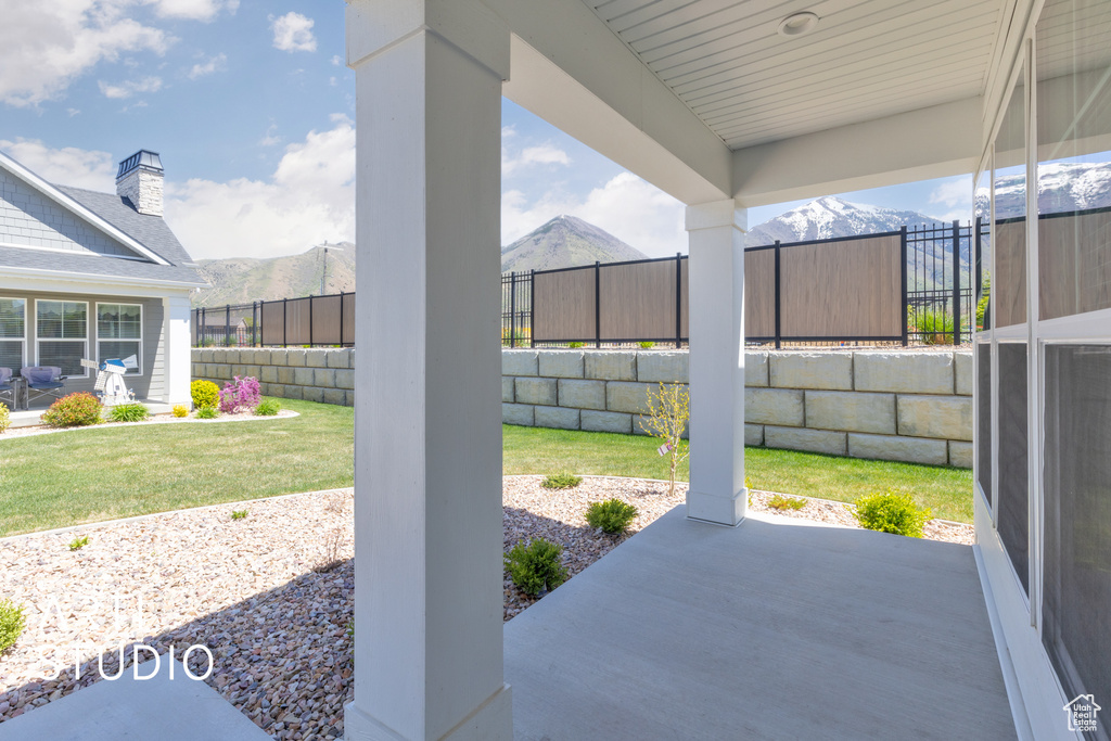 View of patio / terrace with a mountain view and a fenced backyard