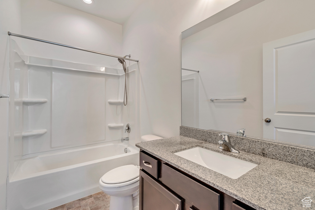 Bathroom with shower / bath combination, vanity, and toilet