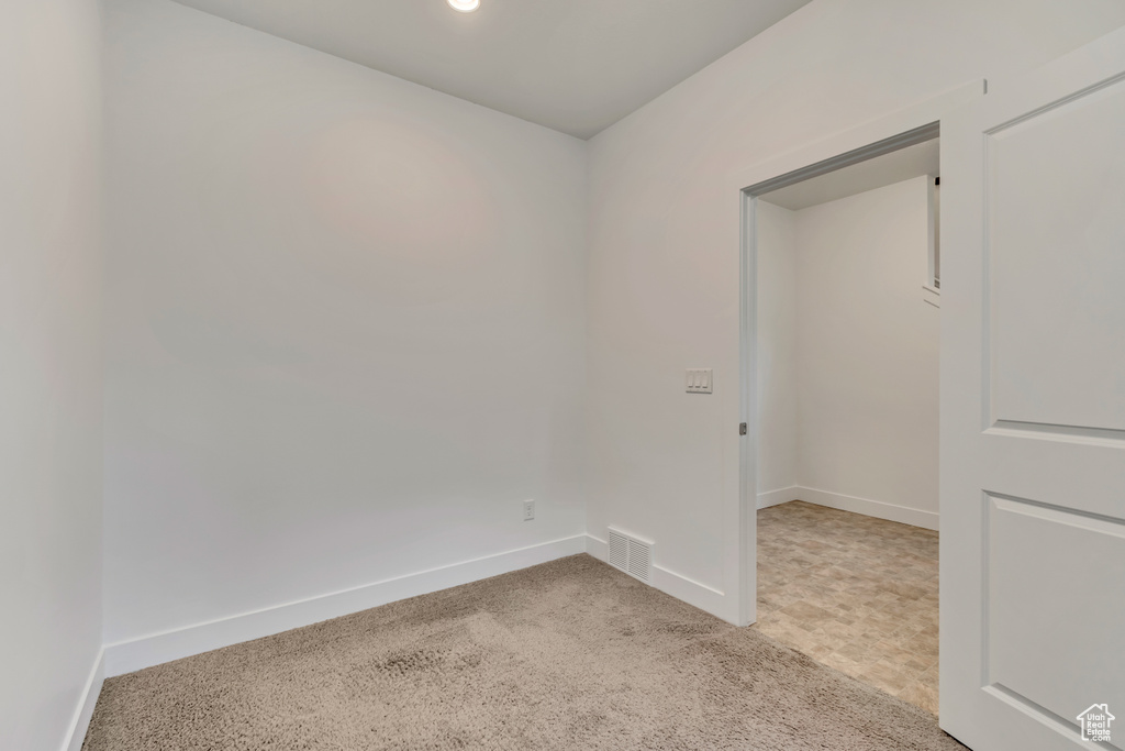 Empty room with baseboards, recessed lighting, visible vents, and carpet floors