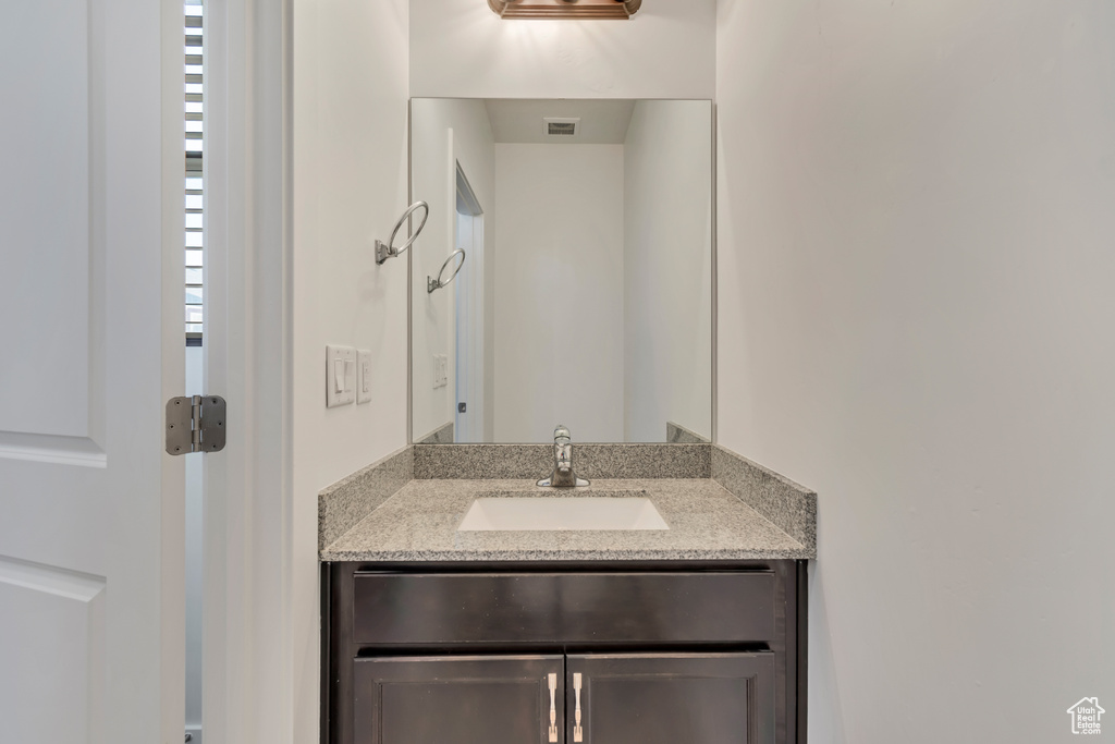 Bathroom featuring visible vents and vanity