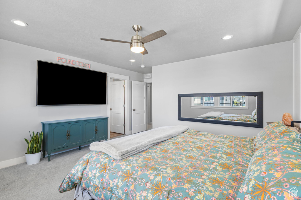 Bedroom featuring ceiling fan, light carpet, baseboards, and recessed lighting