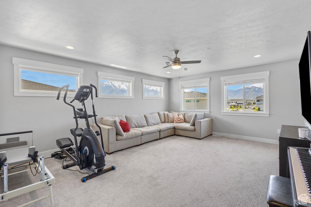 Workout room with baseboards, recessed lighting, ceiling fan, and carpet