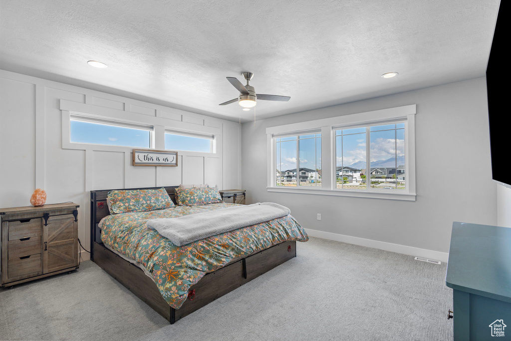 Bedroom with baseboards, carpet flooring, recessed lighting, and a textured ceiling