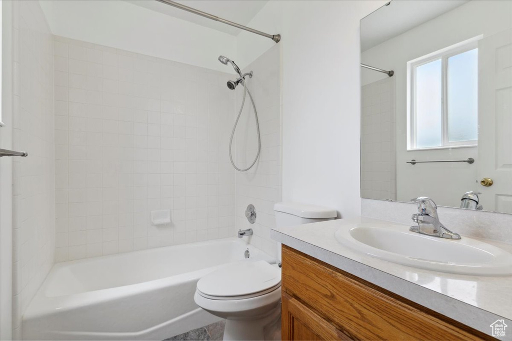 Bathroom with vanity, toilet, and shower / washtub combination