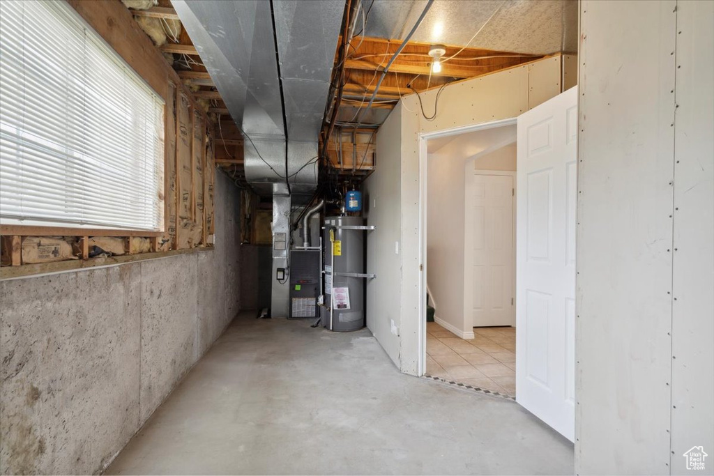 Below grade area with strapped water heater and heating unit