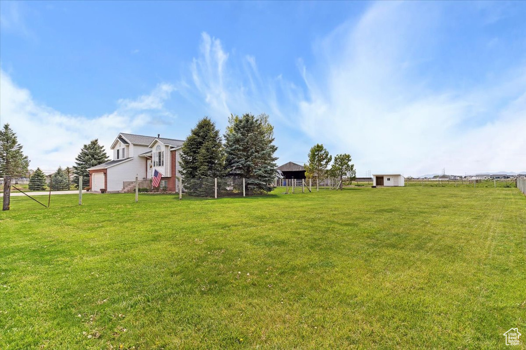 View of yard with a garage and fence