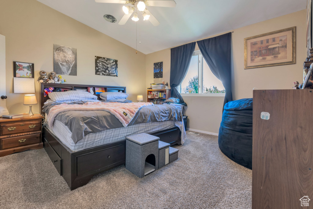 Bedroom featuring carpet, vaulted ceiling, baseboards, and ceiling fan