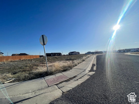 View of street featuring traffic signs, curbs, and sidewalks
