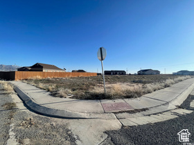 View of street featuring traffic signs, curbs, and sidewalks