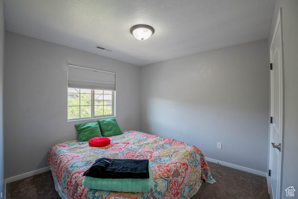 Bedroom featuring visible vents, baseboards, and carpet floors