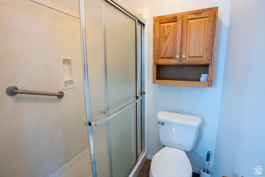 Full bathroom featuring toilet and a stall shower