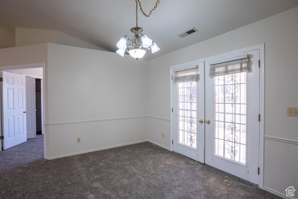 Interior space featuring a notable chandelier, french doors, baseboards, carpet flooring, and visible vents