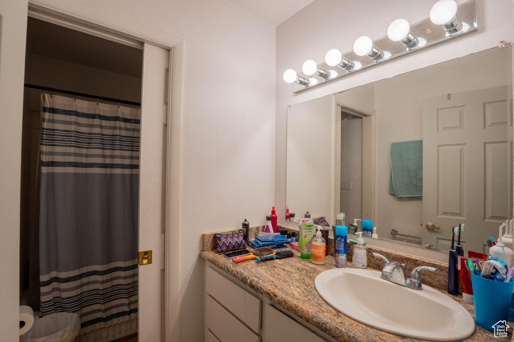 Bathroom featuring vanity and a shower with shower curtain