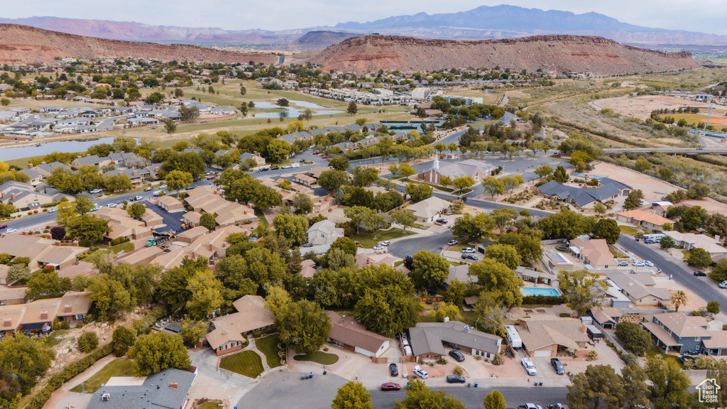 Birds eye view of property featuring a water and mountain view and a residential view