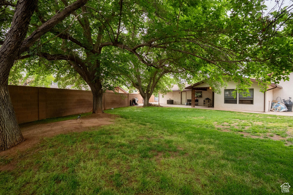 View of yard featuring a patio and a fenced backyard