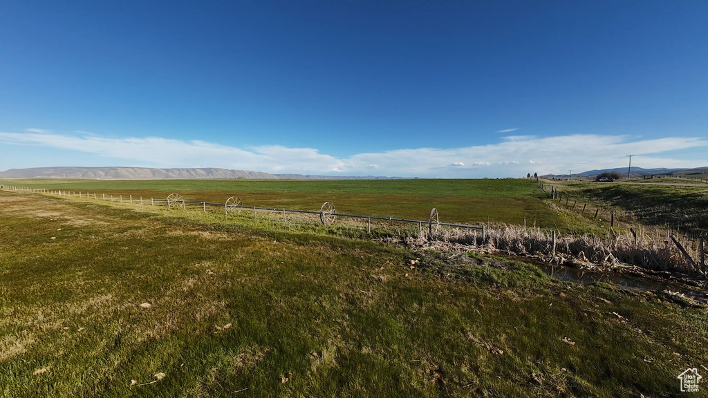 View of yard featuring a rural view and fence
