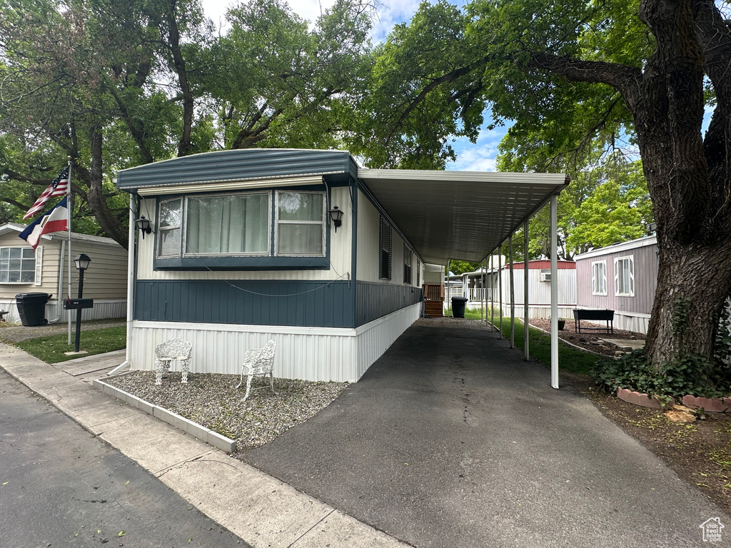 Manufactured / mobile home with an attached carport and driveway