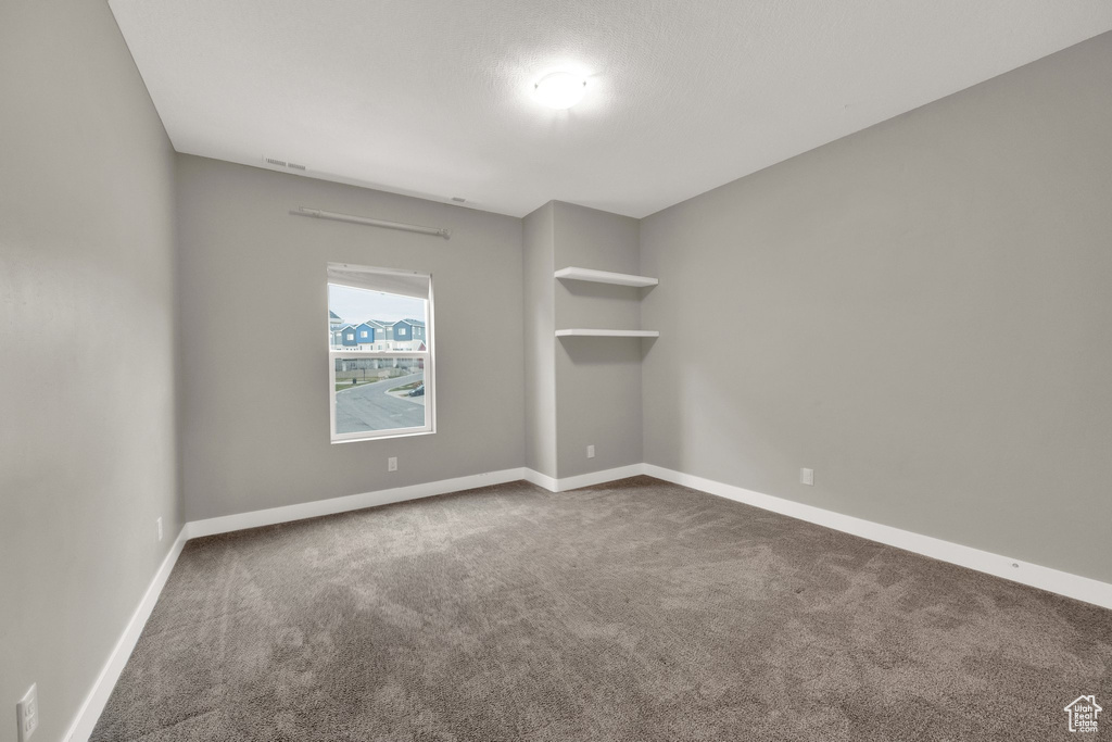 Unfurnished room featuring baseboards and carpet floors