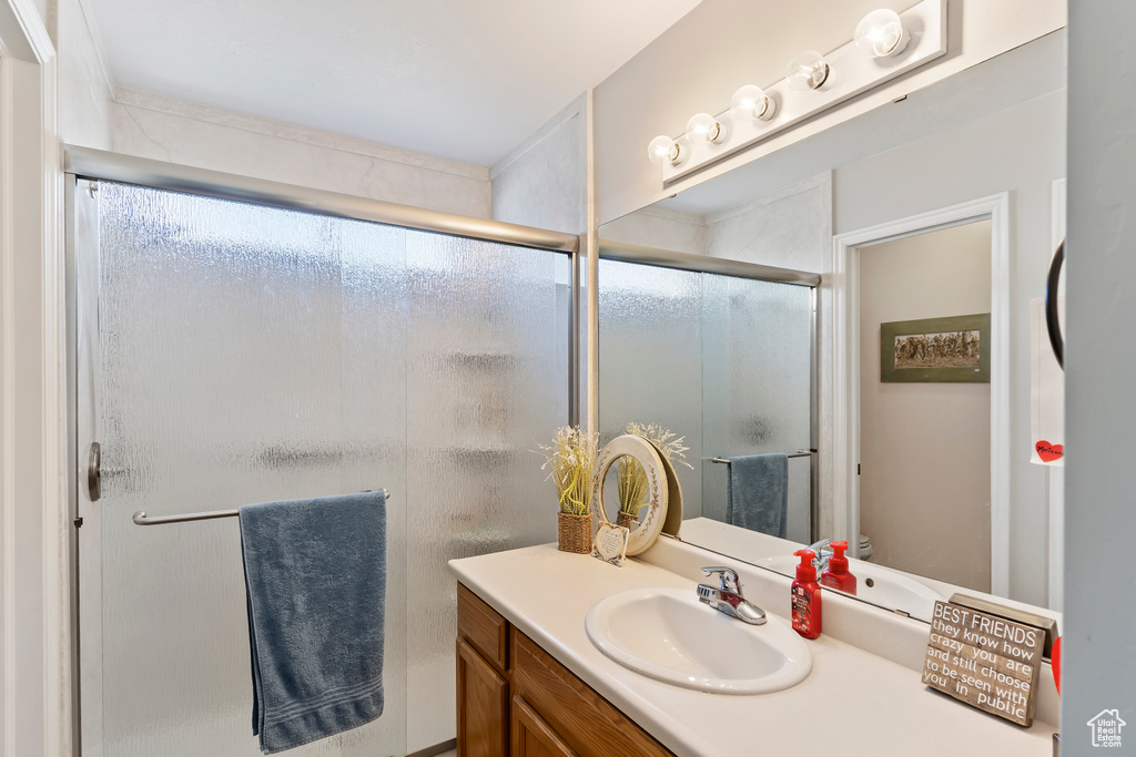Bathroom with a shower stall and vanity