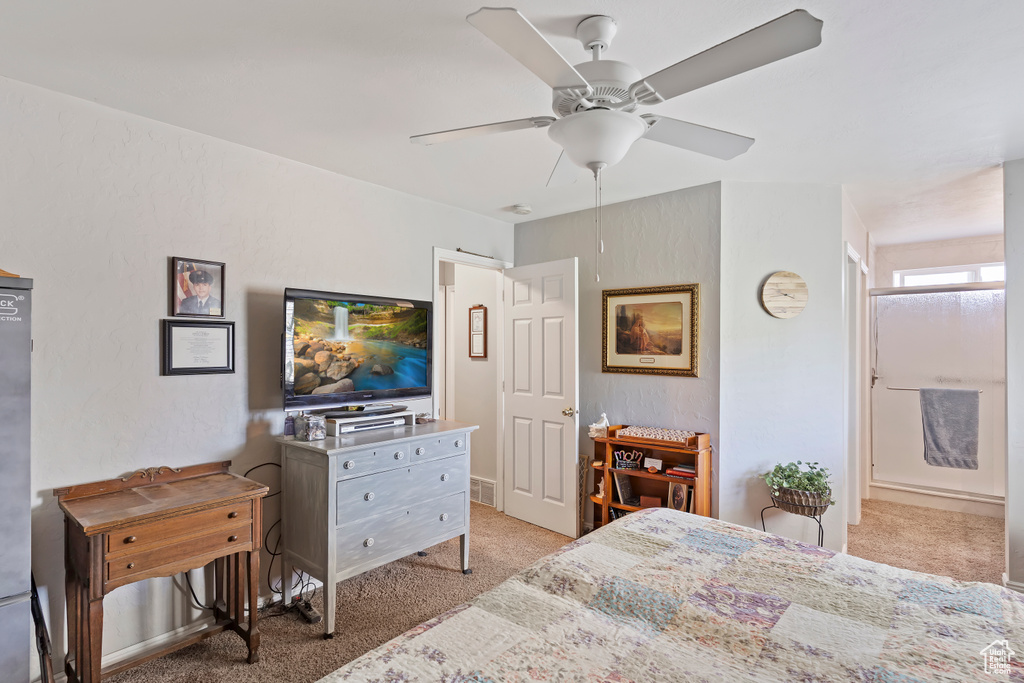 Bedroom featuring a ceiling fan and light carpet
