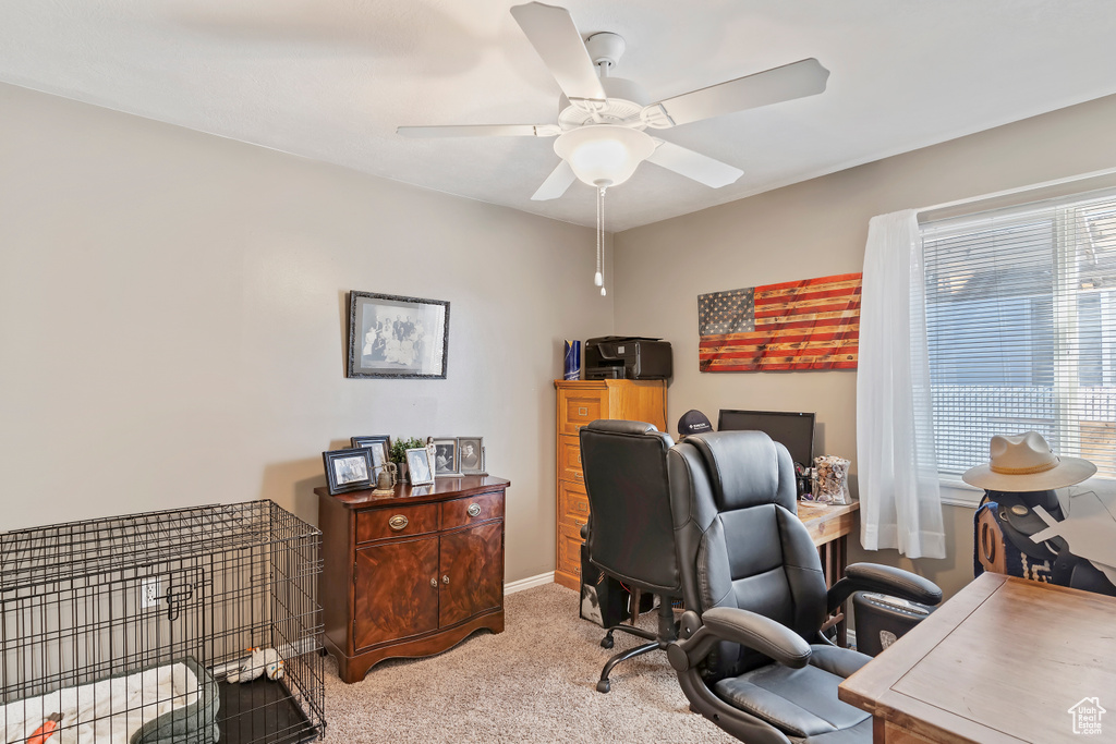 Office featuring baseboards, light carpet, and ceiling fan