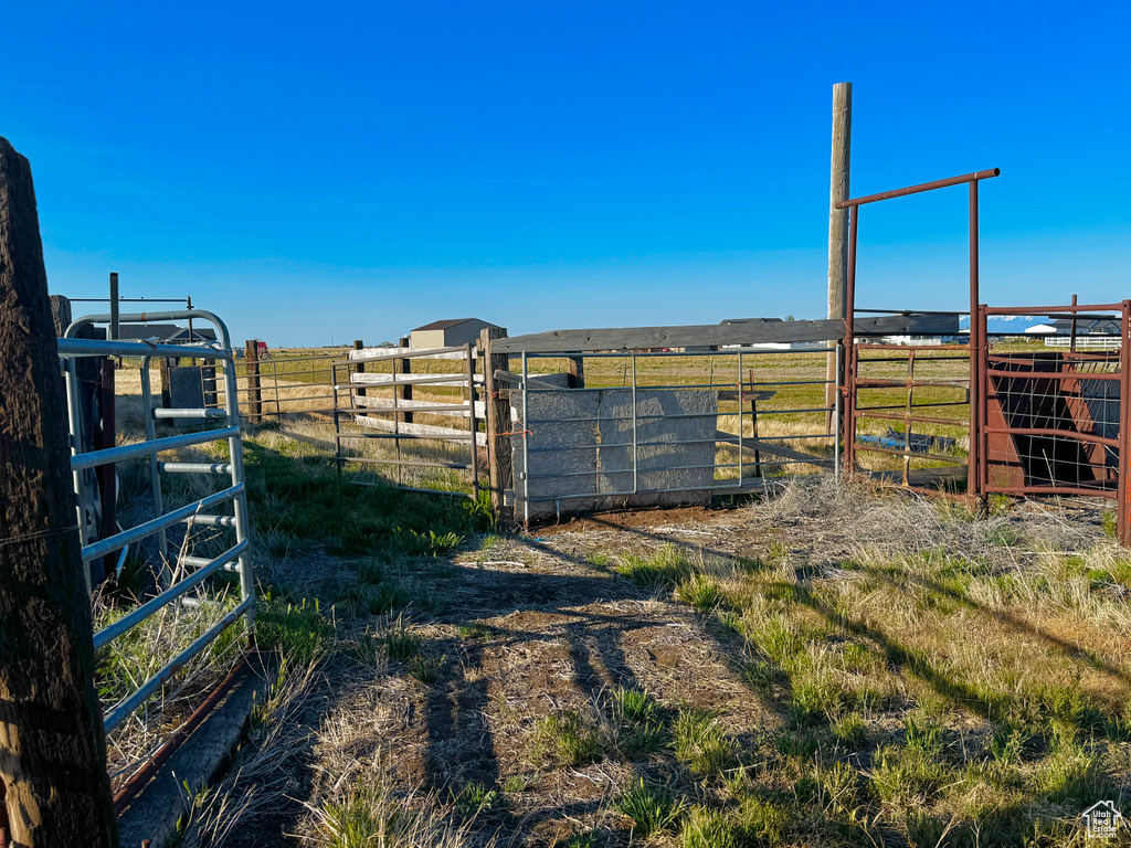 View of yard featuring a rural view and fence