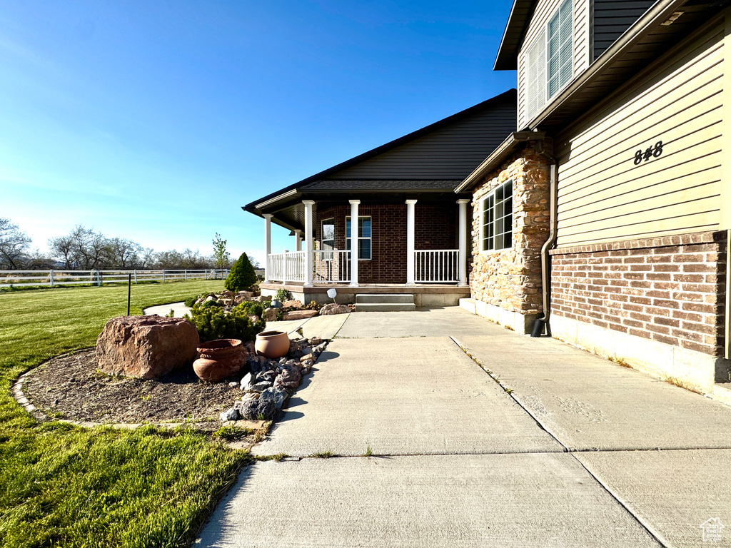 View of patio featuring a porch and fence