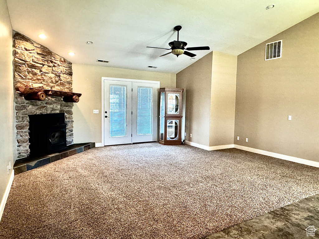 Unfurnished living room featuring visible vents, baseboards, a fireplace, and ceiling fan
