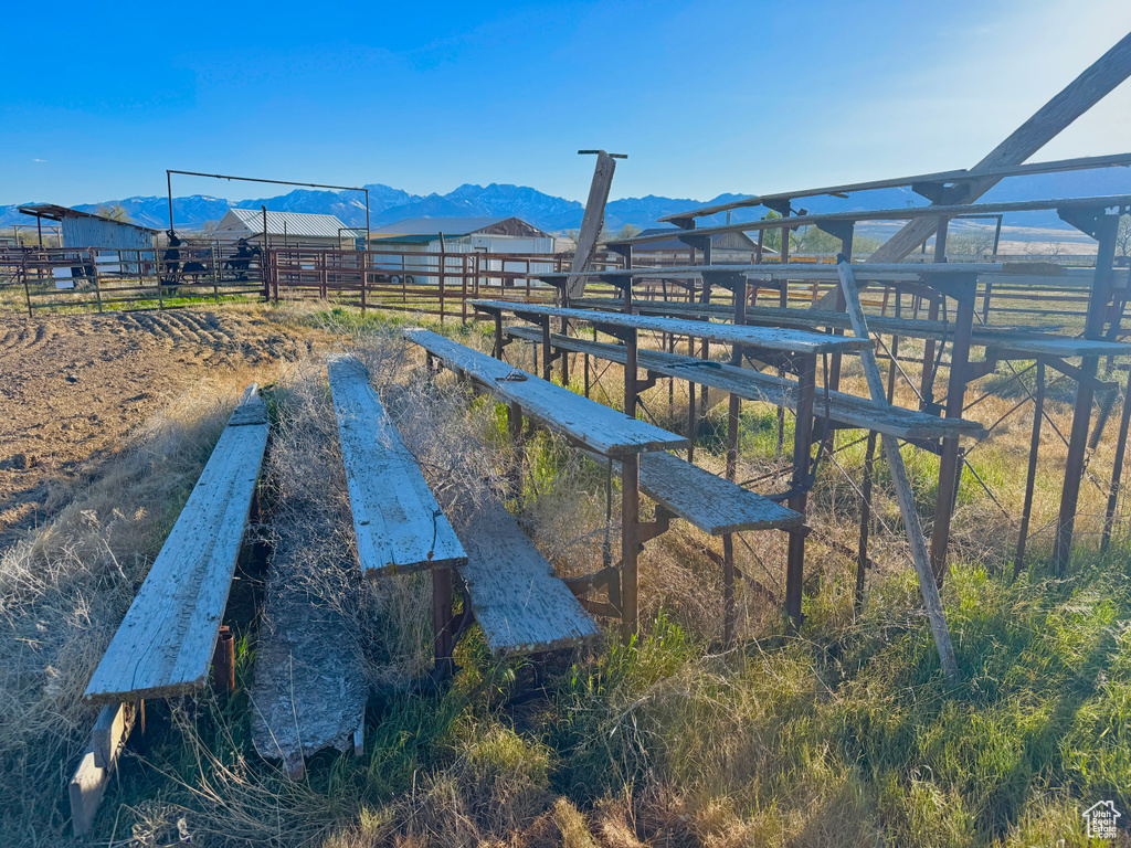 Exterior space with a mountain view, a rural view, fence, and an exterior structure