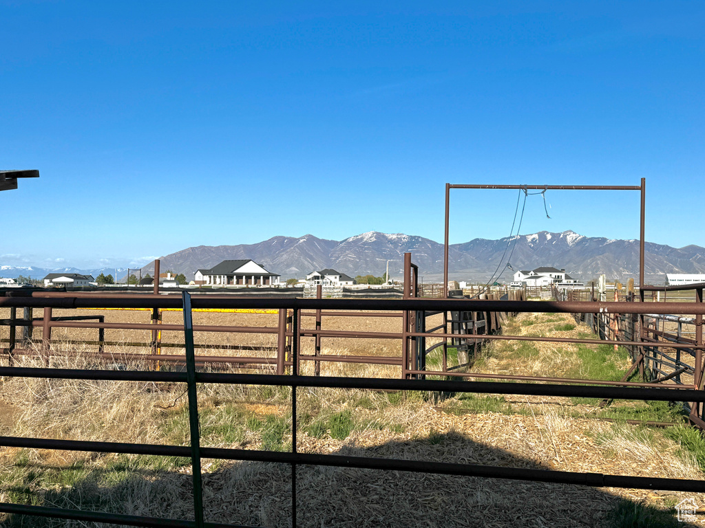 View of yard with a rural view and a mountain view