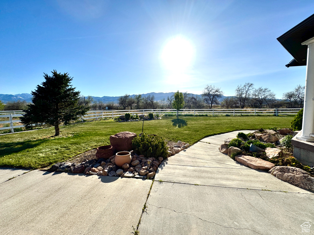 View of patio / terrace featuring a mountain view, a rural view, and a fenced backyard