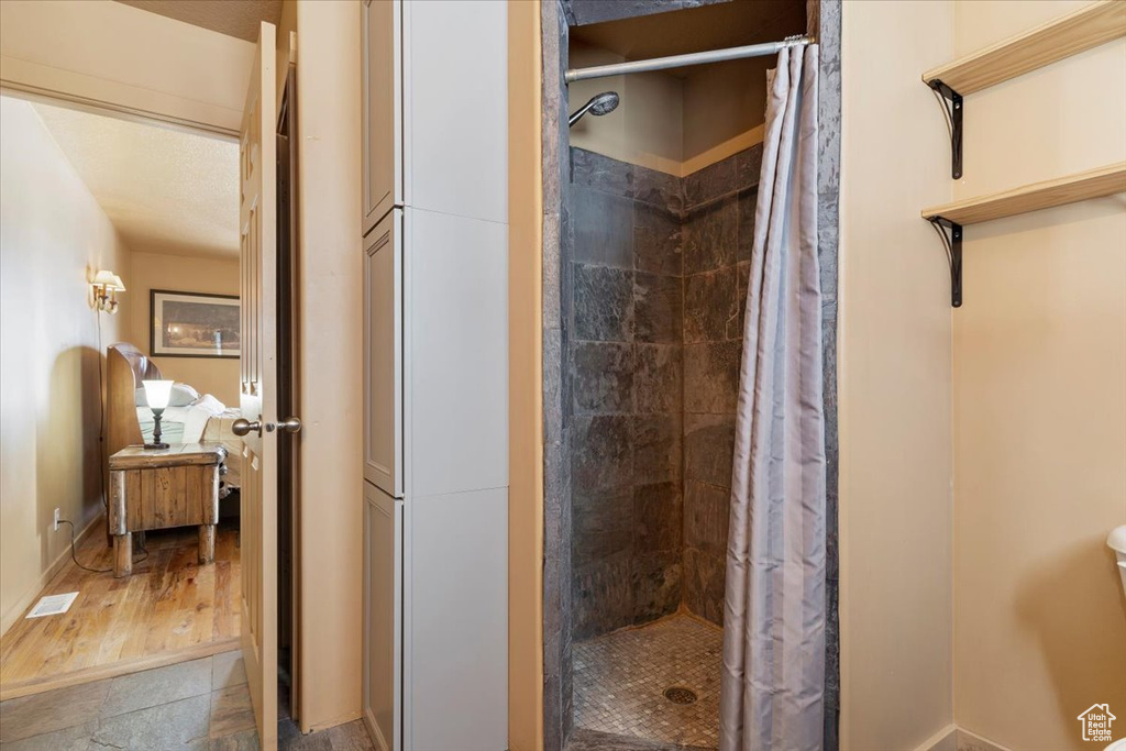 Full bath featuring a stall shower and visible vents