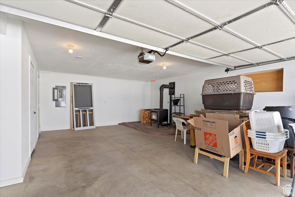 Garage with a wood stove and a garage door opener