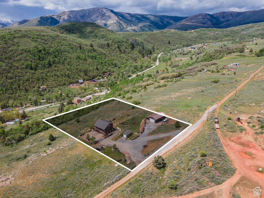 View of rural area with a mountainous background and property boundaries highlighted