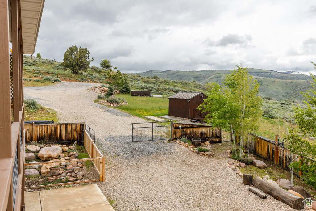 Fenced backyard with a mountain view and a gate
