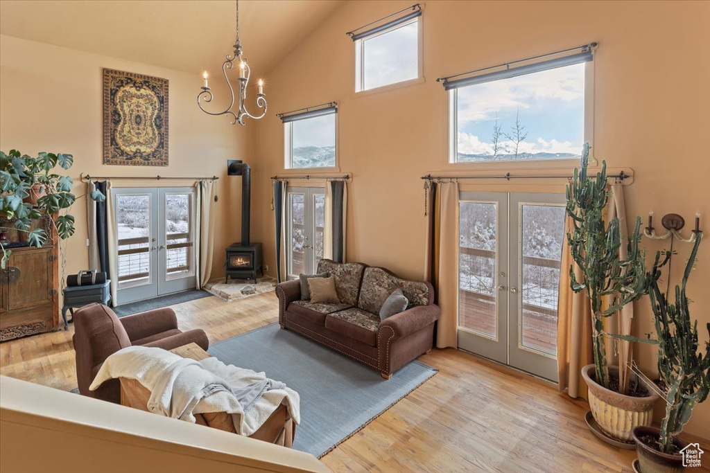 Living area featuring a wood stove, french doors, and wood finished floors