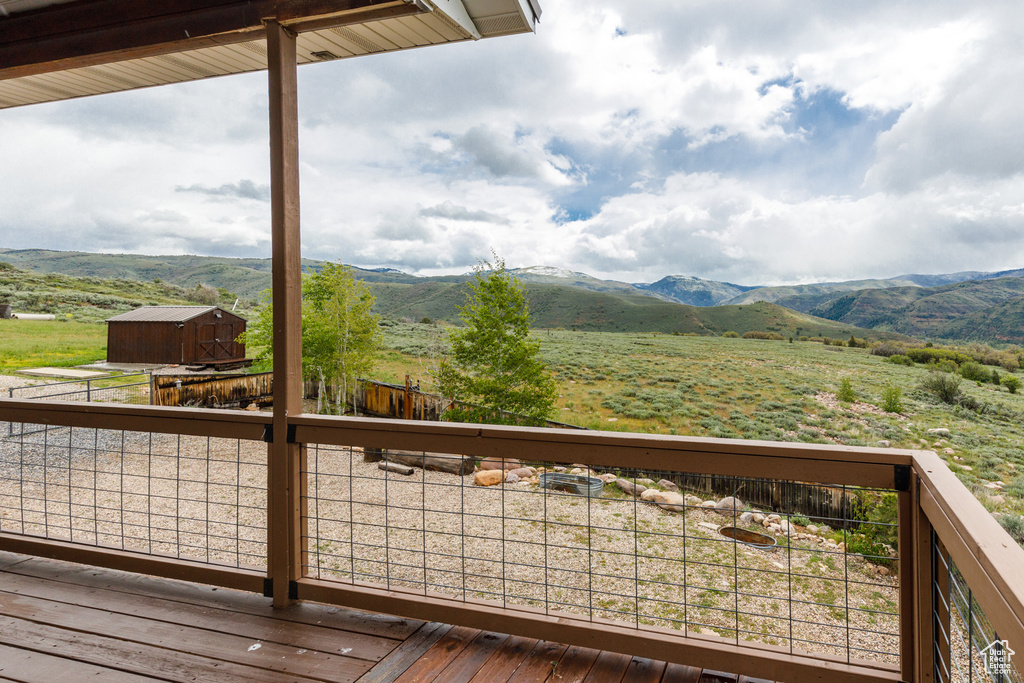 Deck featuring a mountain view, a view of countryside, and an outdoor structure