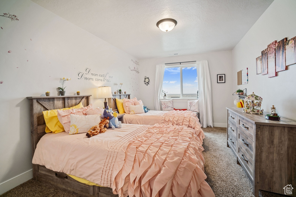 Bedroom with baseboards and carpet
